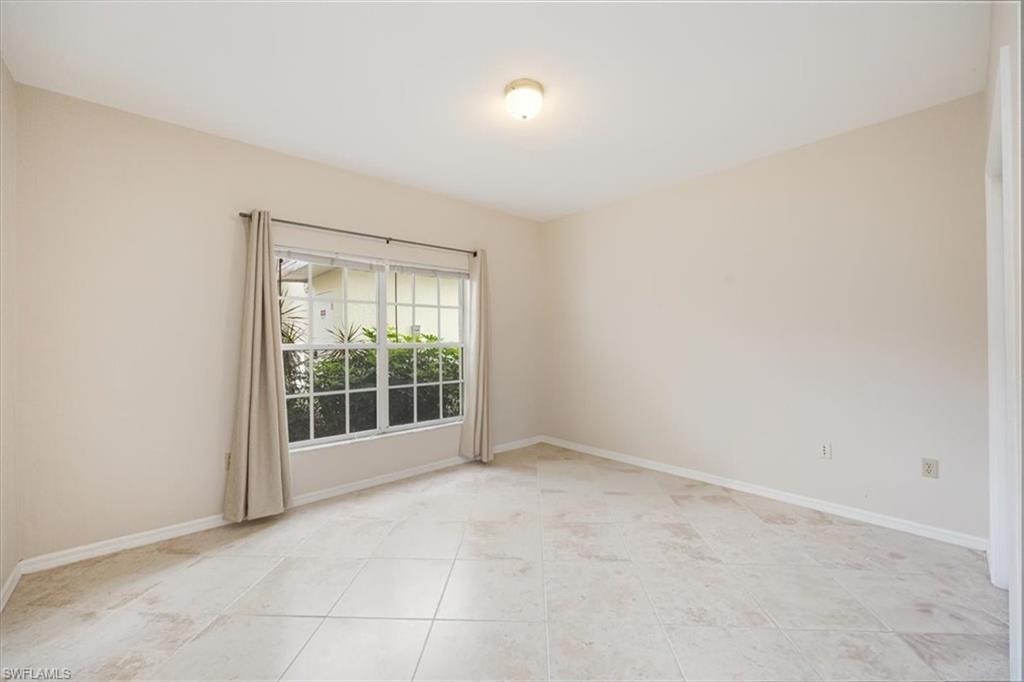 6025 Chardonnay Lane, Unit 103 Naples, FL 34119 - Photo 31 of 45 an empty room with floor to ceiling window