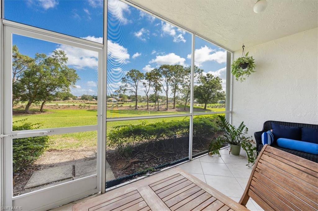 6025 Chardonnay Lane, Unit 103 Naples, FL 34119 - Photo 36 of 45 a view of a porch with a garden