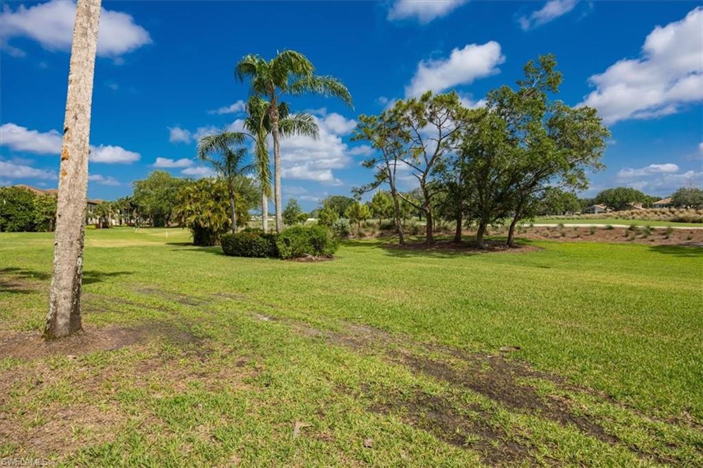 6025 Chardonnay Lane, Unit 103 Naples, FL 34119 - Photo 37 of 45 a front view of a house with a yard