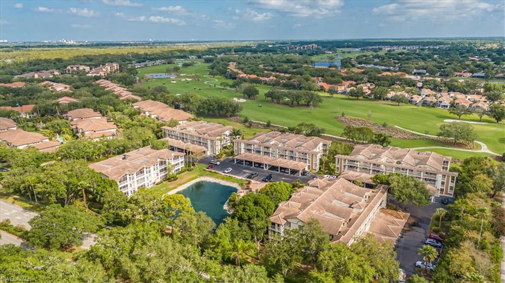 6025 Chardonnay Lane, Unit 103 Naples, FL 34119 - Photo 41 of 45 an aerial view of residential houses with outdoor space and trees