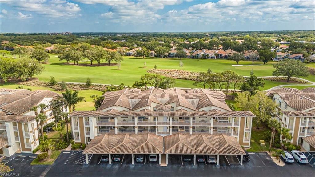 6025 Chardonnay Lane, Unit 103 Naples, FL 34119 - Photo 42 of 45 a view of a city with lawn chairs