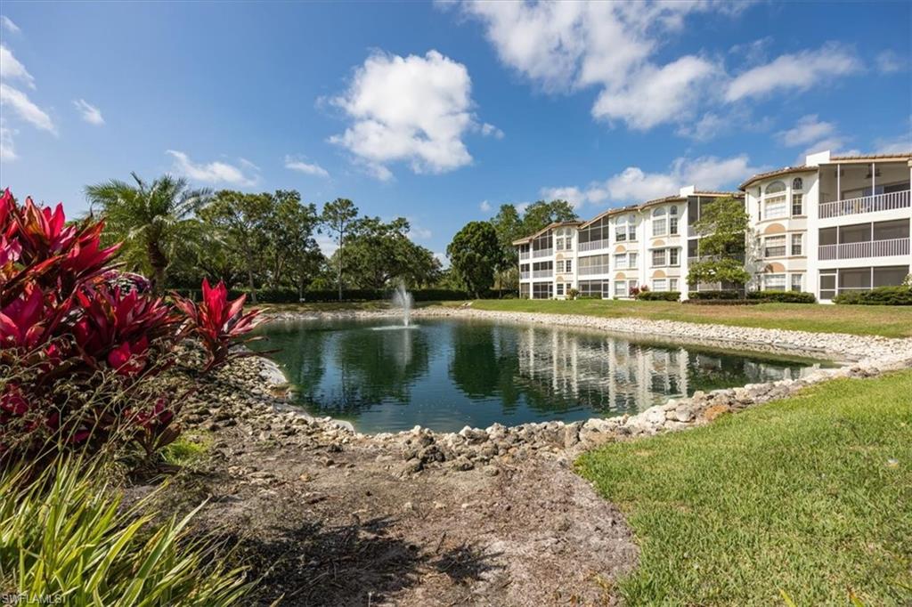 6025 Chardonnay Lane, Unit 103 Naples, FL 34119 - Photo 44 of 45 a view of a lake with a building in the background