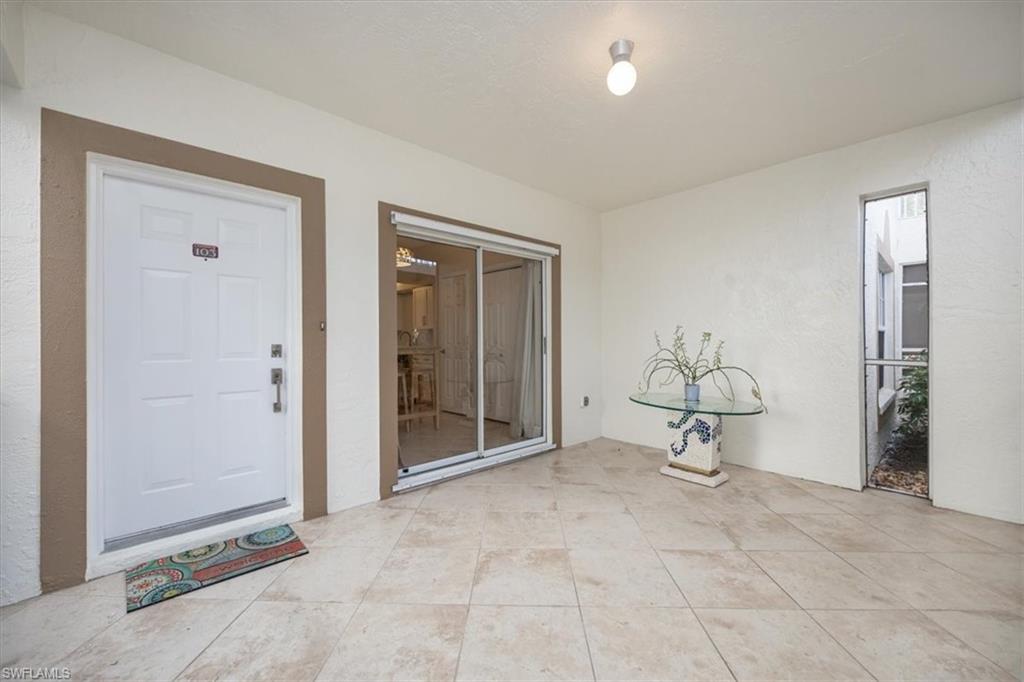 6025 Chardonnay Lane, Unit 103 Naples, FL 34119 - Photo 8 of 45 a view of a room with a table and chair