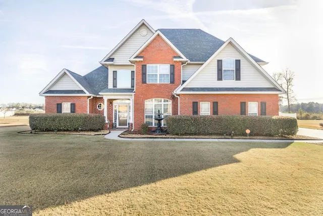 a front view of a house with a yard