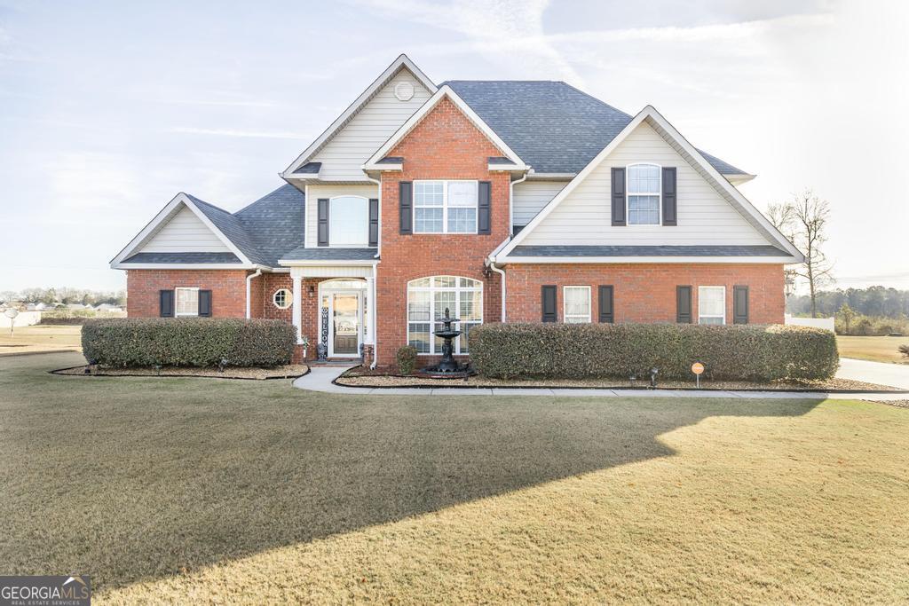 a front view of a house with a yard