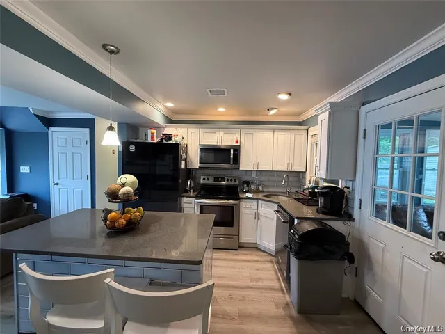 a kitchen with a sink appliances and cabinets