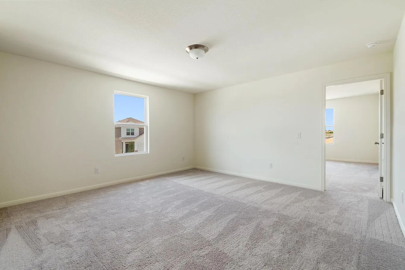 101 Aoudad Road Hutto, TX 78634 - Photo 14 of 39 A quiet, carpeted room with a ceiling light fixture and views of neighboring residences.