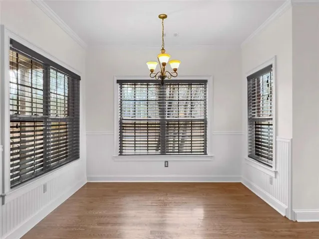 a kitchen with stainless steel appliances granite countertop a stove a sink dishwasher and a fireplace with wooden floor