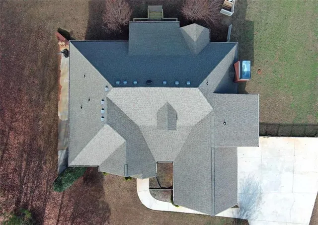 an aerial view of a house with garden space and trees