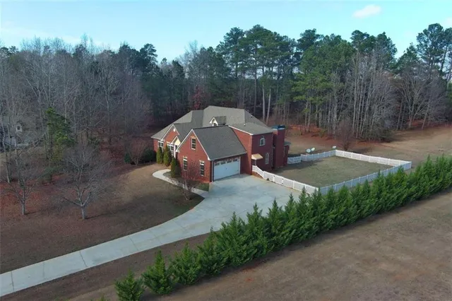 an aerial view of a house with outdoor space