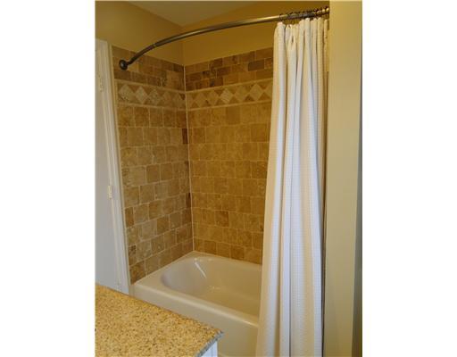 224 Falls Village Road Plum, PA 15239 - Photo 14 of 18 Master Bath/Spa. Gorgeous travertine floor and surround with bowed shower rod.