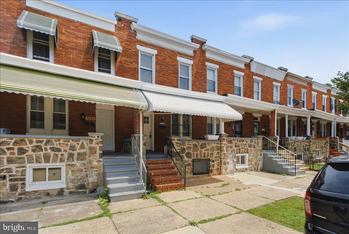 1231 North Potomac Street Baltimore, MD 21213 - Photo 2 of 25 a front view of a building with outdoor shower