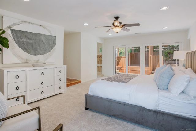 a bedroom with a large bed and a dresser