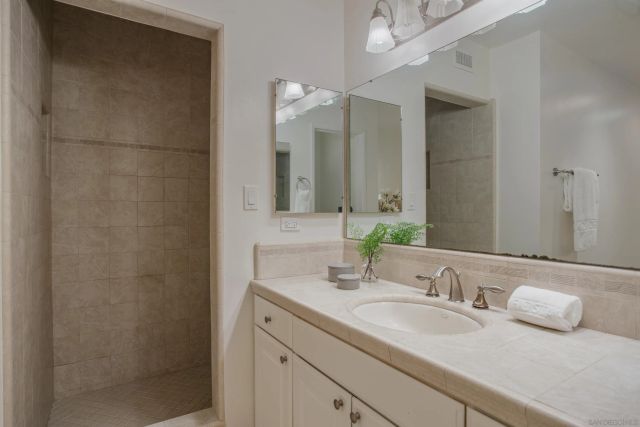 a bathroom with a double vanity sink and a mirror