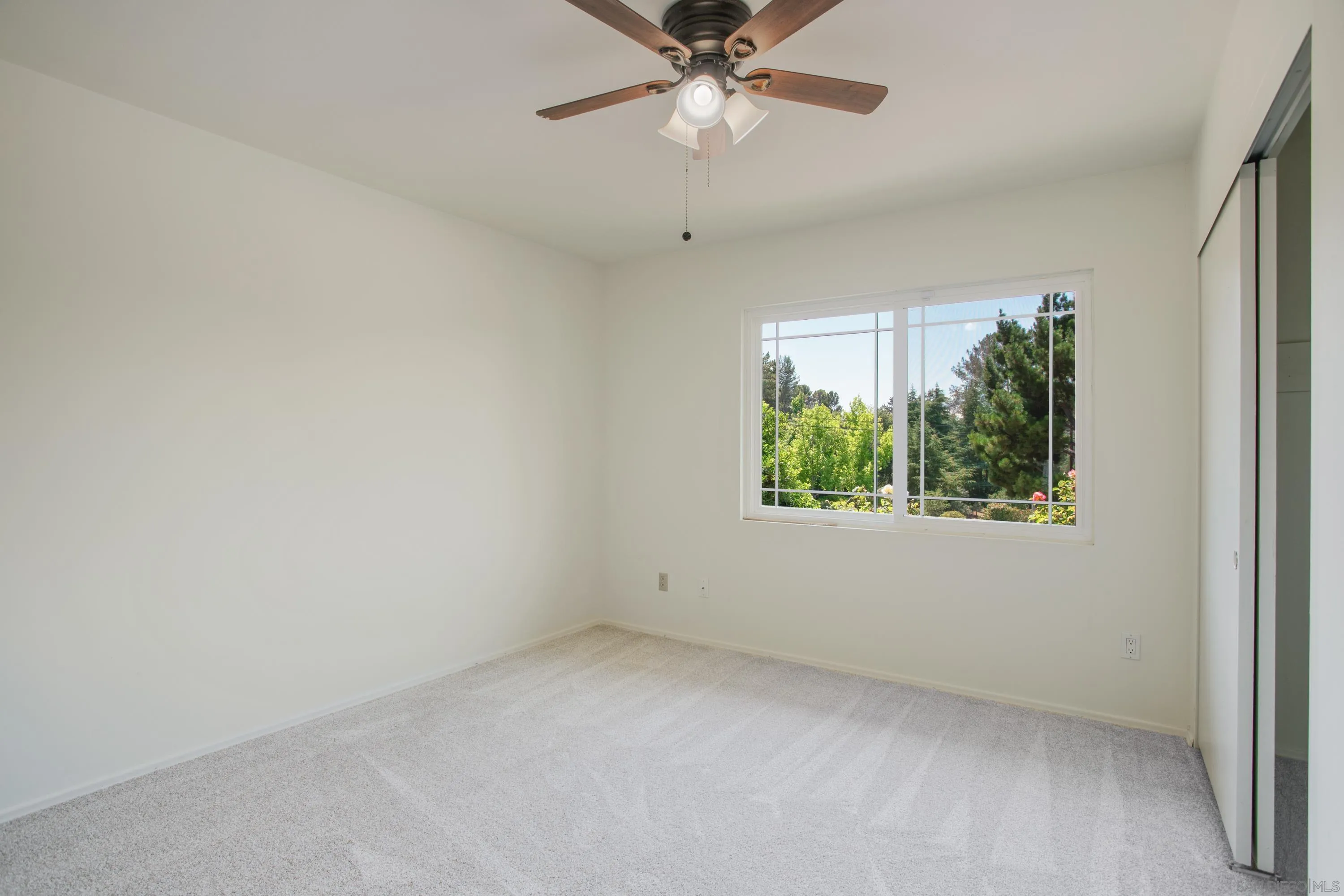 16355 Orchard Bend Road Poway, CA 92064 - Photo 22 of 49 an empty room with a window and a ceiling fan