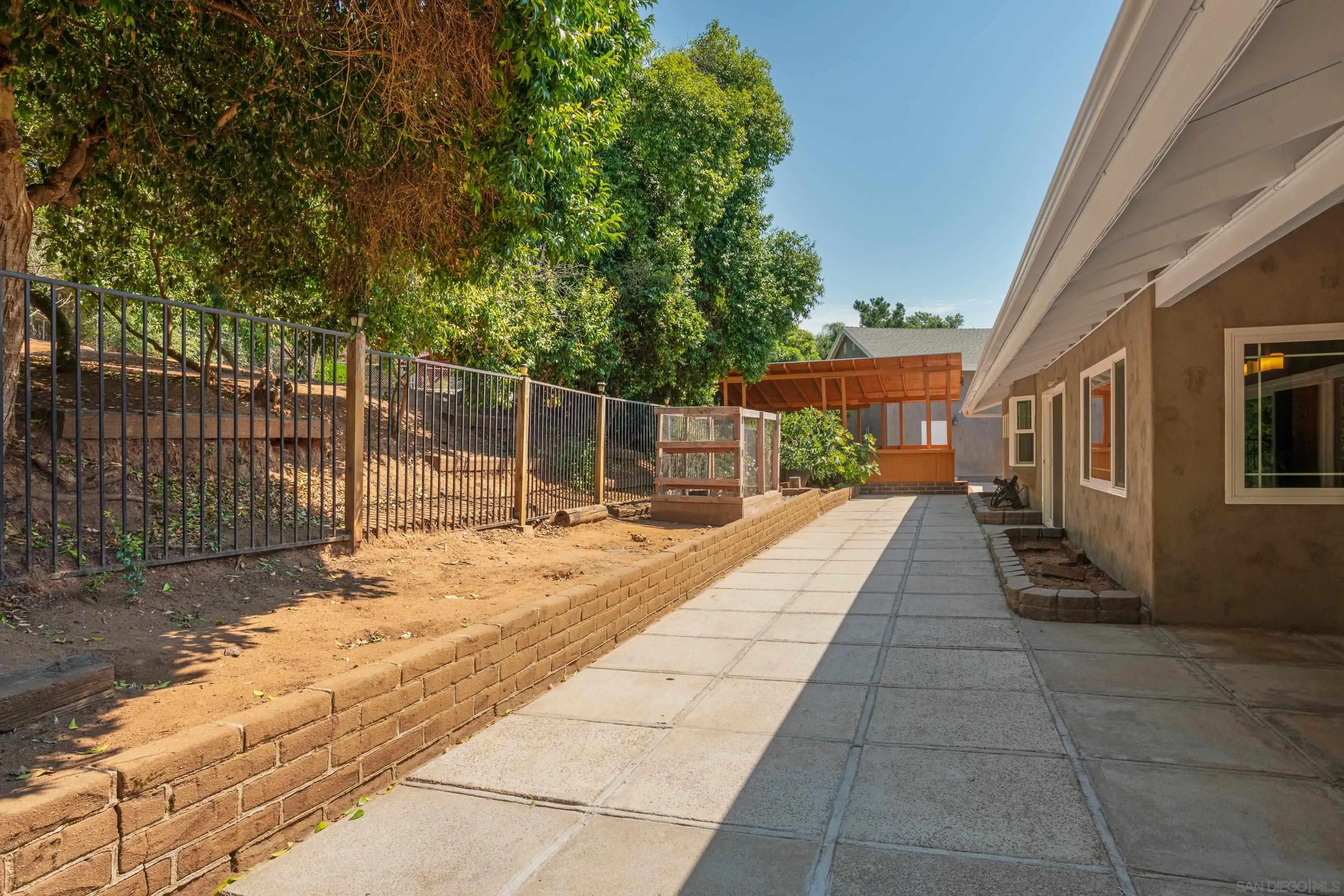 16355 Orchard Bend Road Poway, CA 92064 - Photo 28 of 49 a view of a backyard with couches and wooden fence