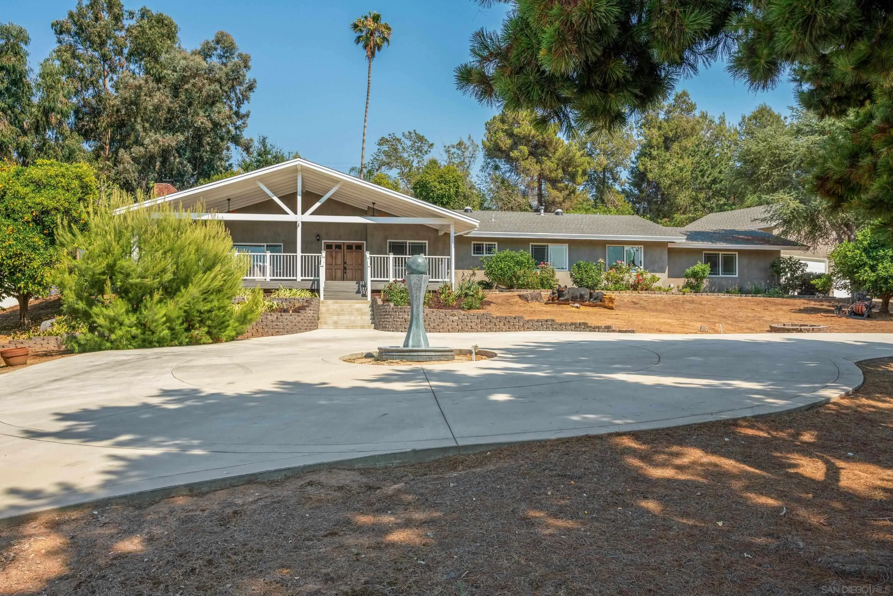 16355 Orchard Bend Road Poway, CA 92064 - Photo 36 of 49 a front view of a house with a yard and potted plants