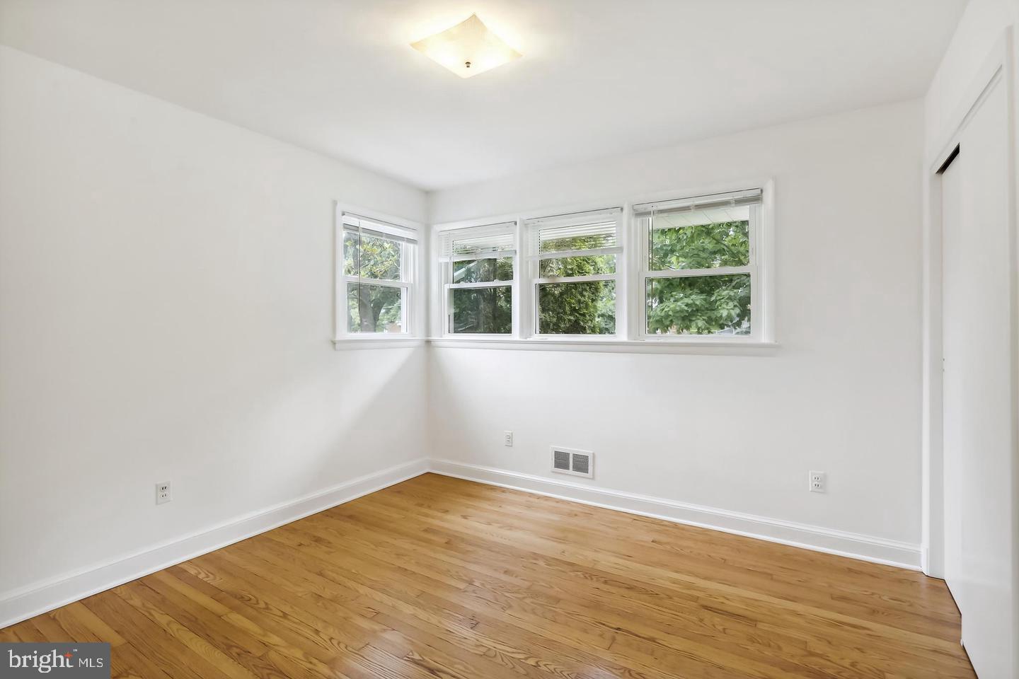 1702 Franwall Avenue Silver Spring, MD 20902 - Photo 12 of 17 an empty room with wooden floor and windows