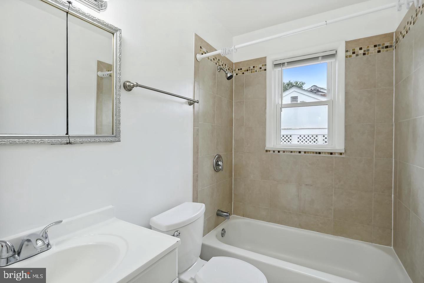 1702 Franwall Avenue Silver Spring, MD 20902 - Photo 13 of 17 a bathroom with a bathtub shower sink vanity and toilet
