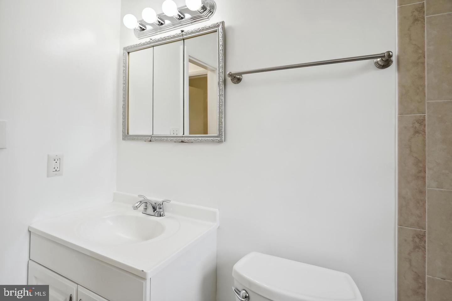 1702 Franwall Avenue Silver Spring, MD 20902 - Photo 14 of 17 a bathroom with a toilet a sink and mirror