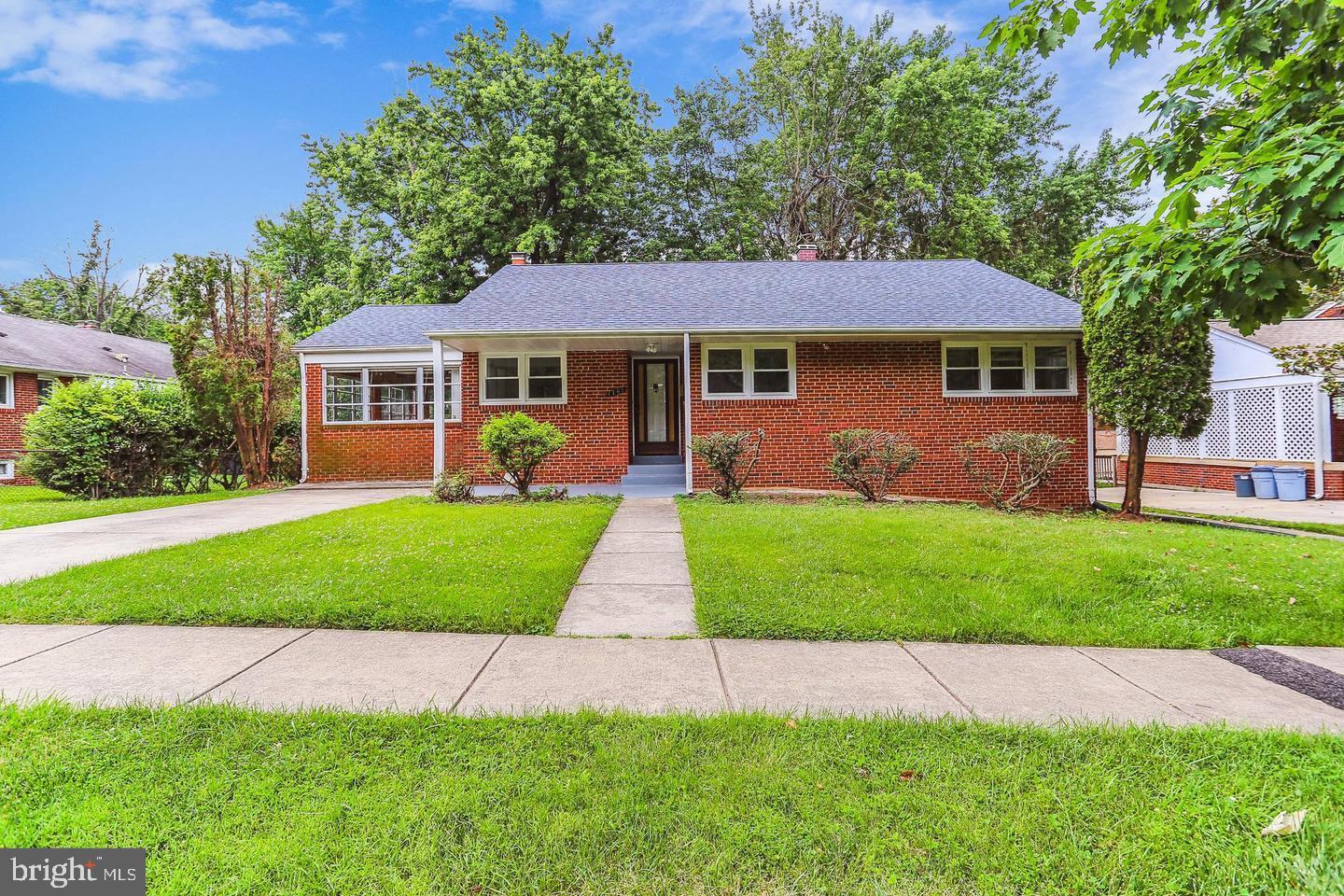 1702 Franwall Avenue Silver Spring, MD 20902 - Photo 2 of 17 a front view of a house with a garden and yard