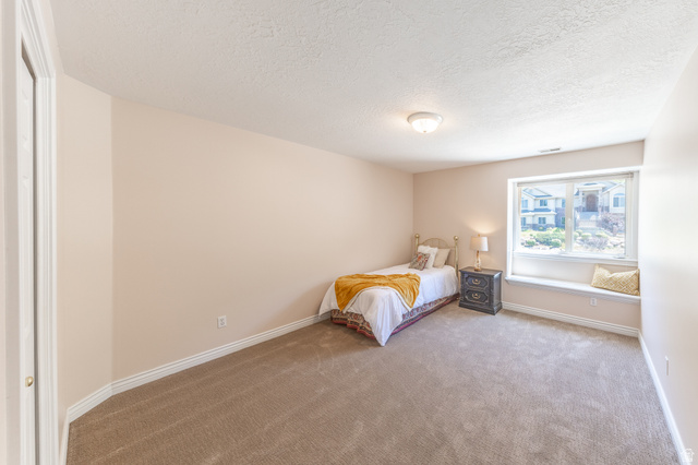 144 Bountiful Boulevard Bountiful, UT 84010 - Photo 19 of 28 Carpeted bedroom with a textured ceiling and baseboards