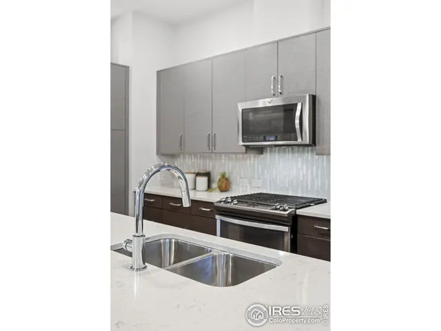 a kitchen with a sink and a stove top oven