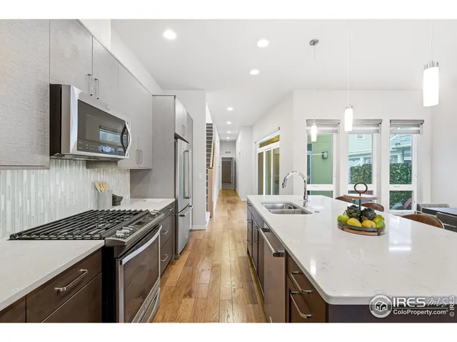 a kitchen with a stove a sink and a refrigerator