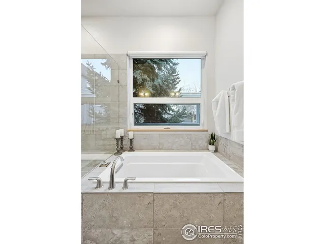 a bath tub sitting in a bathroom next to a window