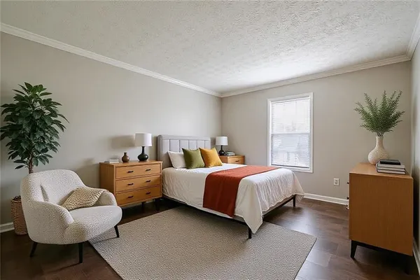 a bedroom with two beds and a potted plant