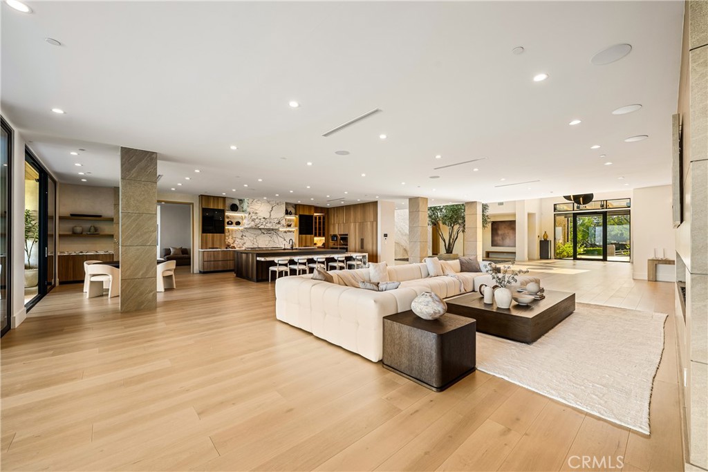 25079 Jim Bridger Road Hidden Hills, CA 91302 - Photo 12 of 73 a living room with furniture kitchen view and a large window
