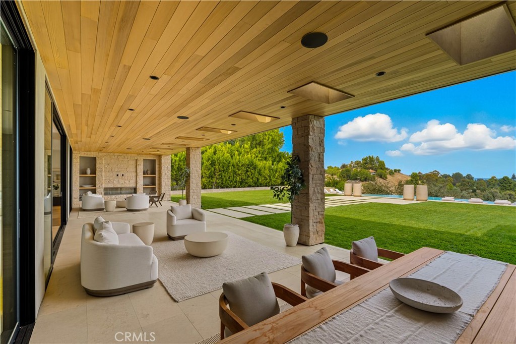 25079 Jim Bridger Road Hidden Hills, CA 91302 - Photo 42 of 73 a view of a patio with couches chairs and a big yard
