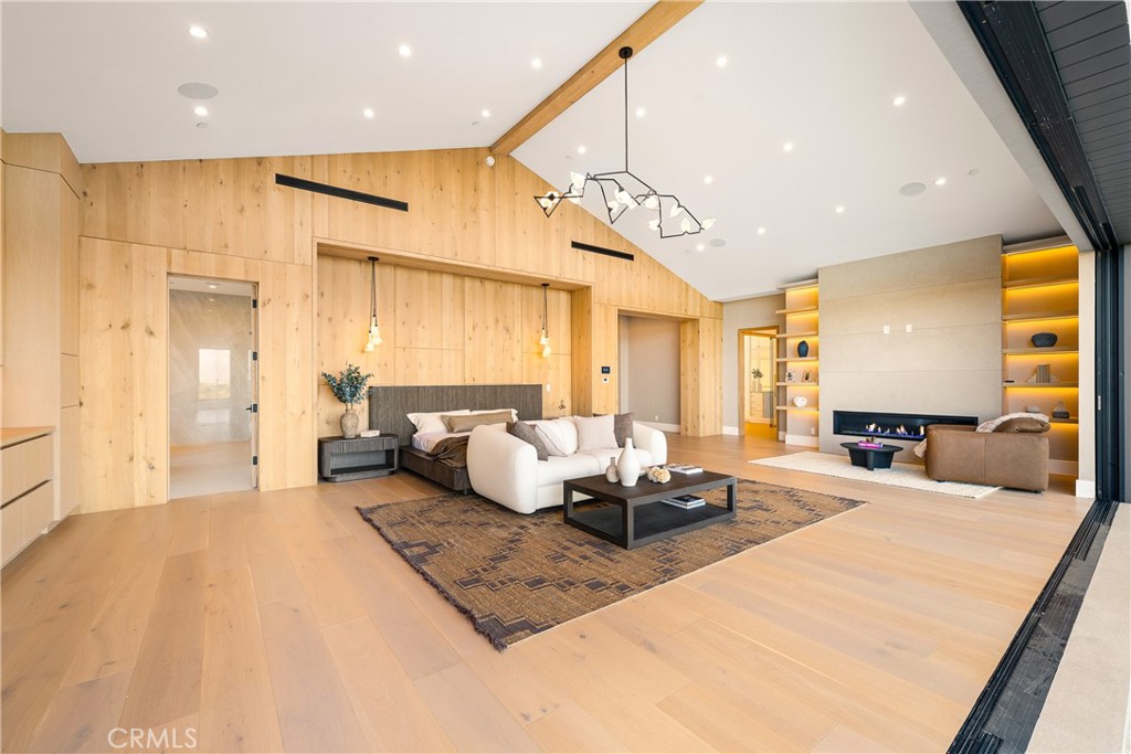 25079 Jim Bridger Road Hidden Hills, CA 91302 - Photo 51 of 73 a large bedroom with a large bed and a chandelier