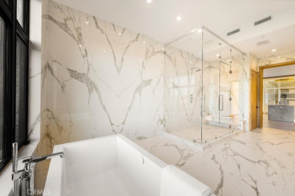 25079 Jim Bridger Road Hidden Hills, CA 91302 - Photo 61 of 73 a bathroom with a bathtub and shower