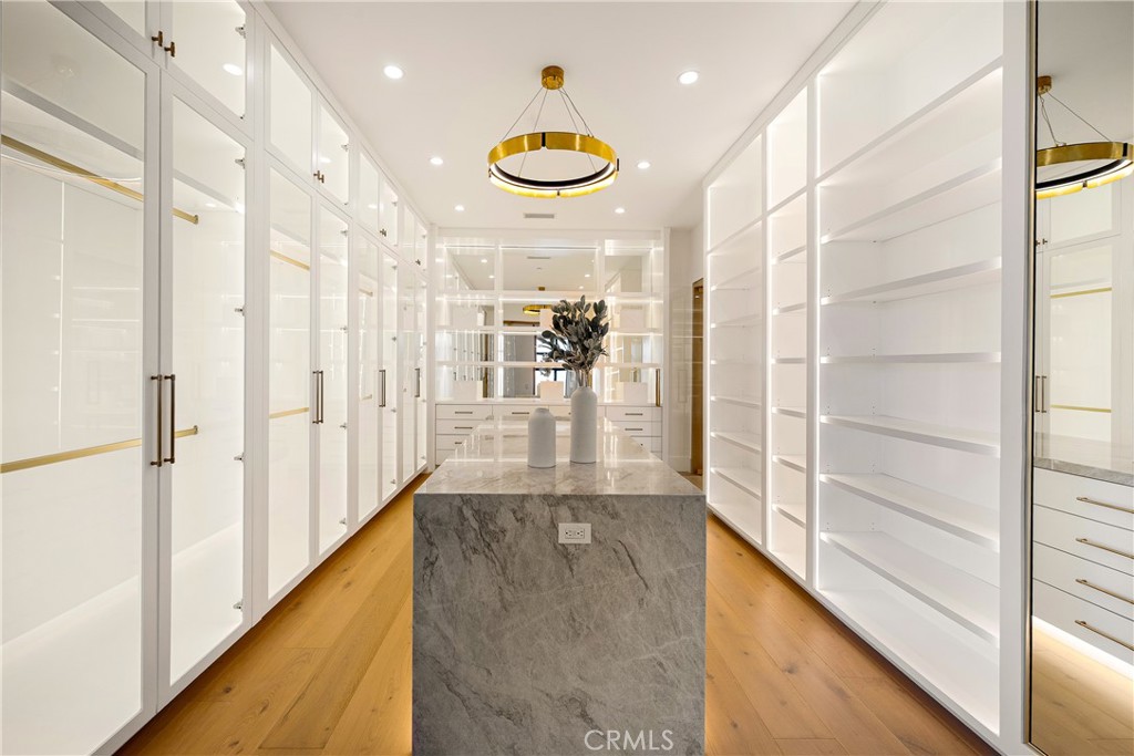 25079 Jim Bridger Road Hidden Hills, CA 91302 - Photo 62 of 73 a view of a hallway with wooden floor and a glass door
