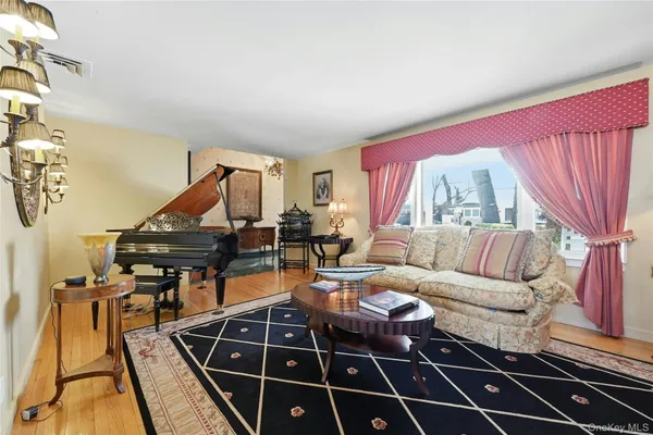 a living room with furniture pool table and a rug