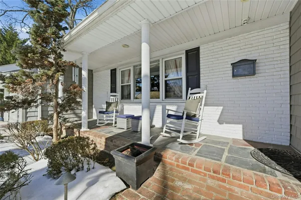 a view of a patio with couches table and chairs and potted plants