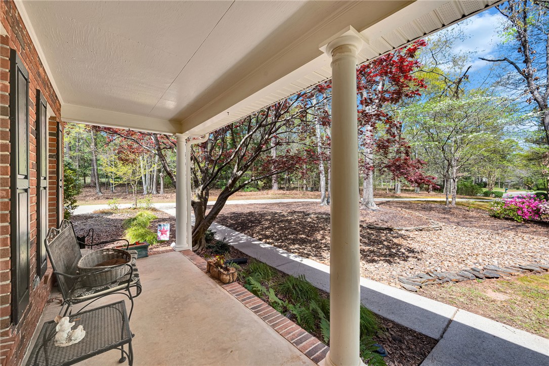 1010 Ridgeview Drive Pendleton, SC 29670 - Photo 4 of 47 Relax outdoors on this welcoming porch overlooking a serene, treed landscape.
