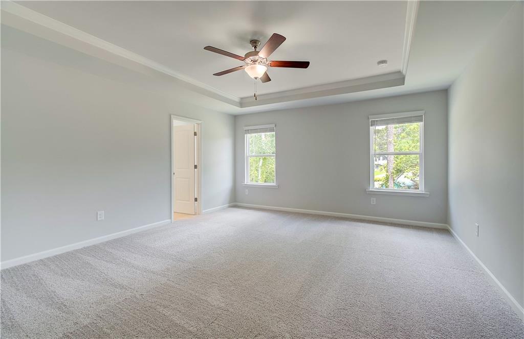 117 Alpine Road Fairburn, GA 30213 - Photo 20 of 29 an empty room with windows and ceiling fan