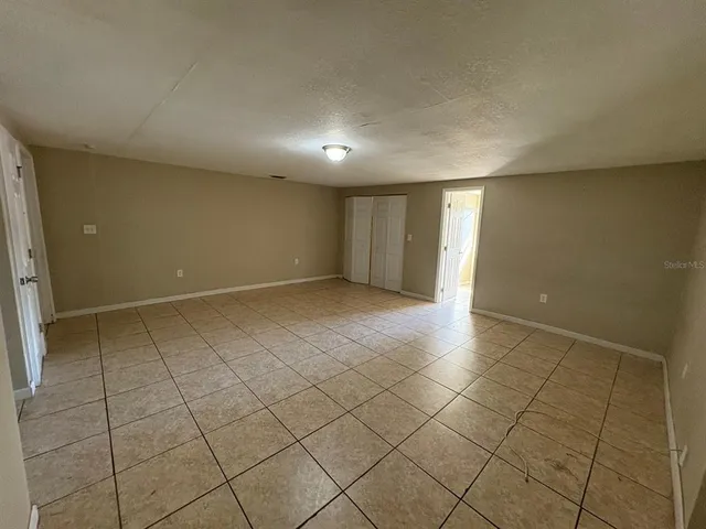 a view of an empty room and a window