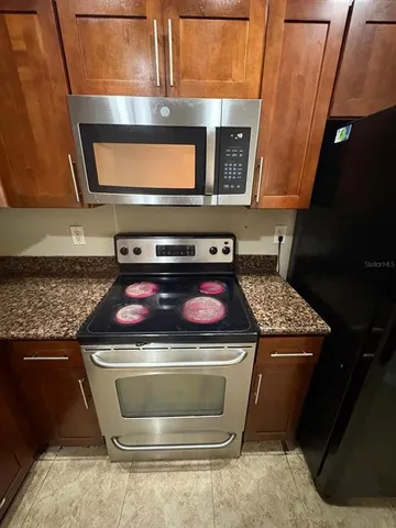 a stove top oven sitting inside of a kitchen
