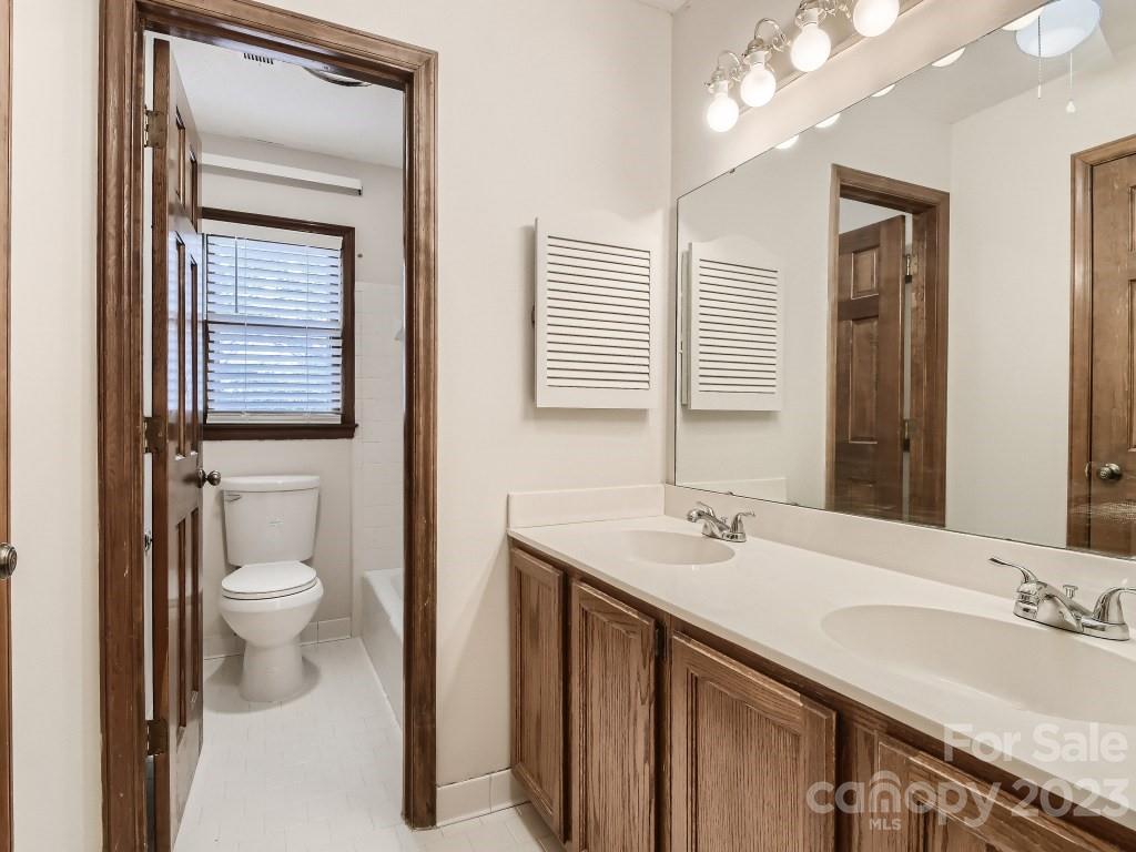2500 Round Table Road, Unit B Monroe, NC 28110 - Photo 14 of 20 a bathroom with a granite countertop sink toilet and shower
