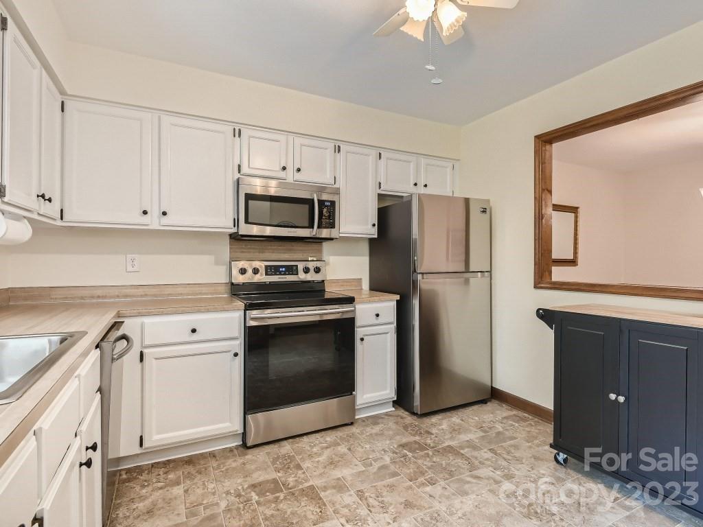 2500 Round Table Road, Unit B Monroe, NC 28110 - Photo 7 of 20 a kitchen with a refrigerator sink and cabinets