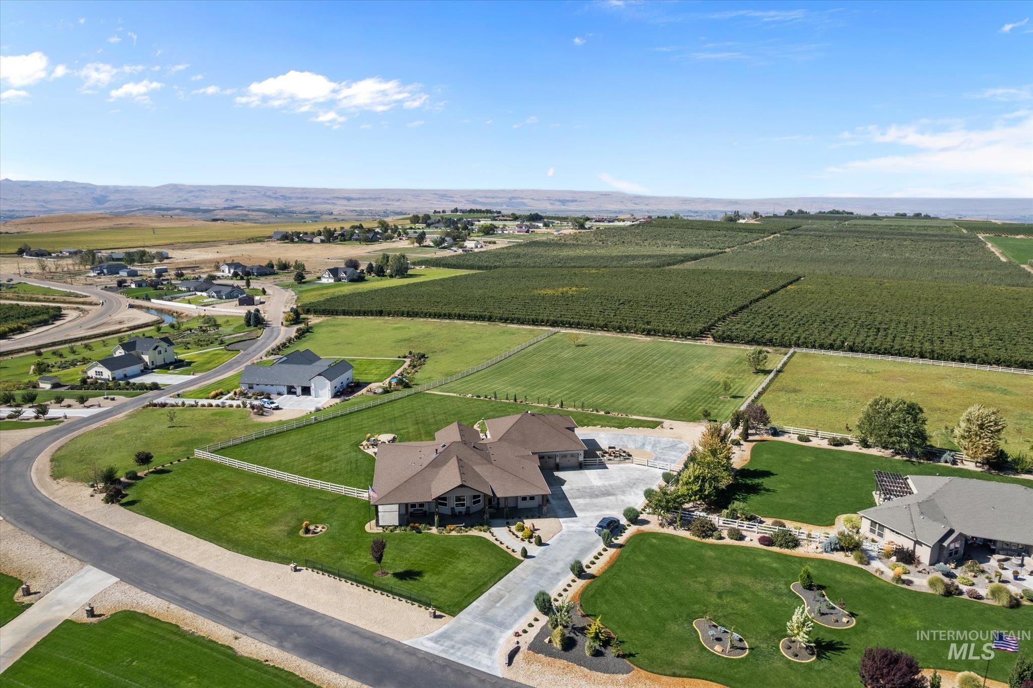 13683 Hockberger Ranch Road Caldwell, ID 83607 - Photo 40 of 50 Spacious property with extensive green lawns, mature landscaping, paved driveways, a multi-wing residence, and a three-car garage