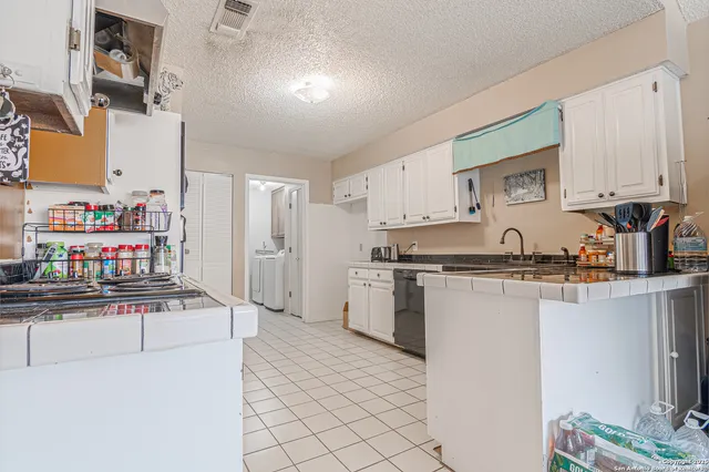 a kitchen with stainless steel appliances a sink and a refrigerator