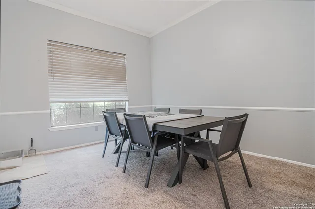 a view of a dining room with furniture and window