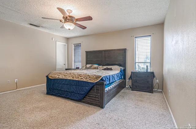 a bedroom with a bed and window