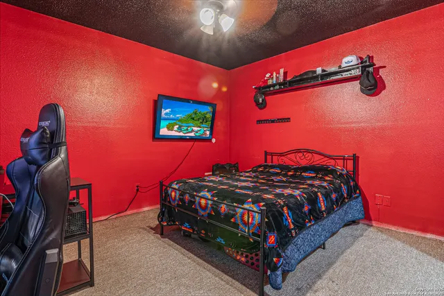 a bedroom with a bed and a mirror