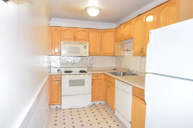 a kitchen with a stove a sink and a window