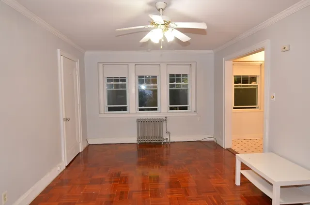a view of empty room with a window and ceiling fan